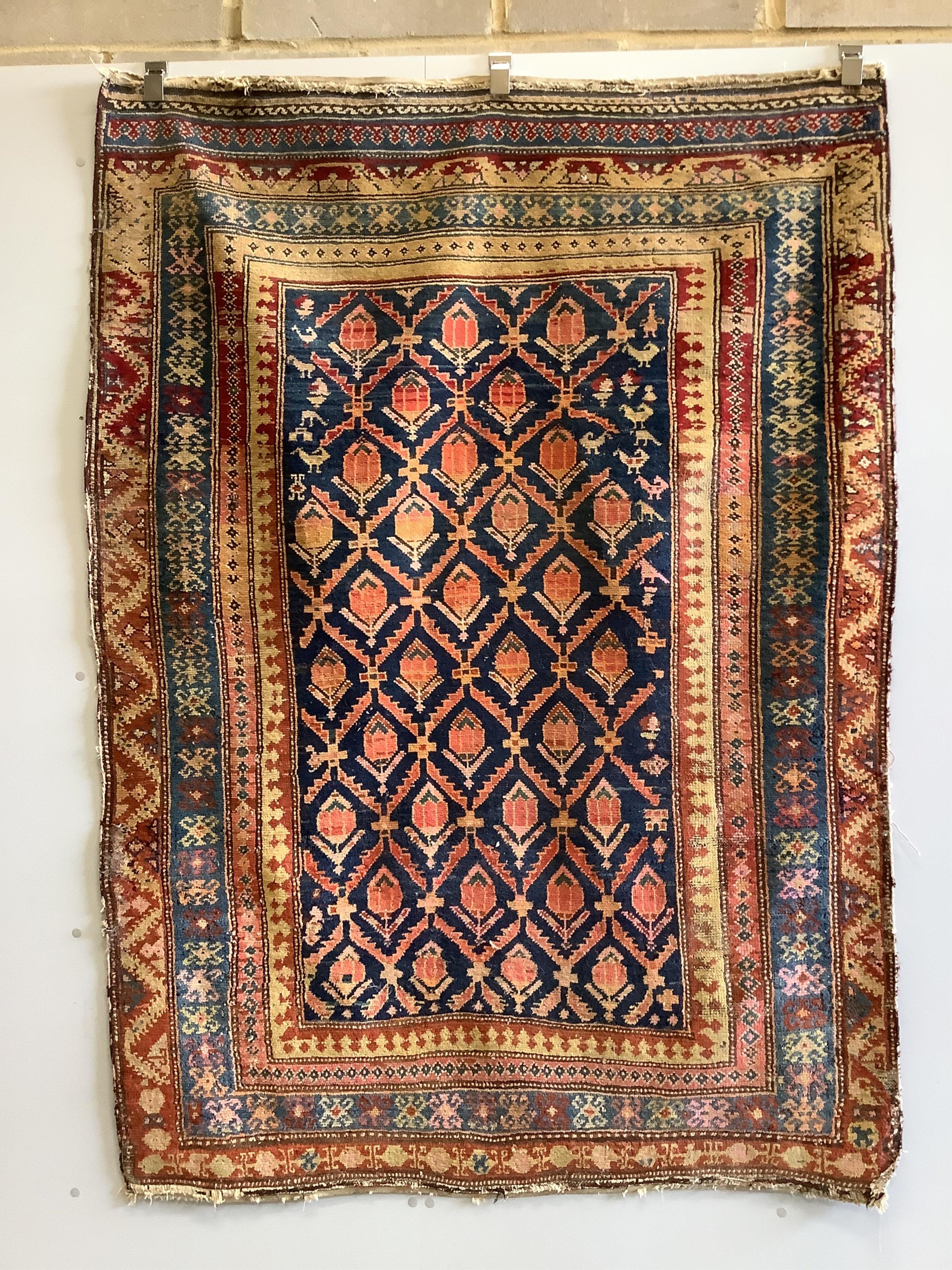 A Caucasian blue ground rug with flower motifs, 180 x 130cm. Condition - fair
